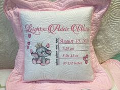 a pink and white pillow with an elephant on it