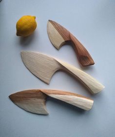 three different types of wood carving tools on a table next to a lemon and knife