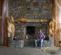 a man sitting in front of a stone fire place with two bears on each side