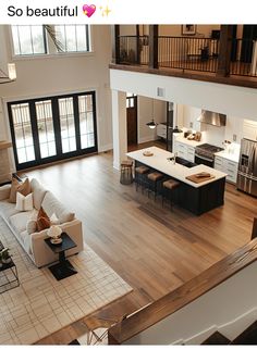 an aerial view of a living room, kitchen and dining area from the second floor