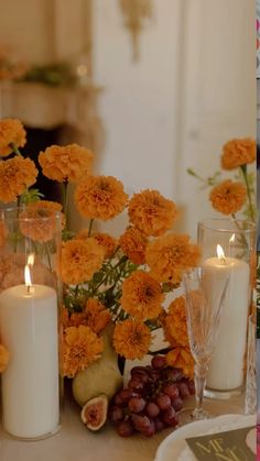 candles, flowers and fruit on a table