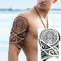 a man with a tattoo on his arm and chest next to the ocean in front of him