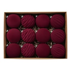 twelve red round macaroons in a cardboard box