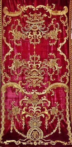 a red velvet and gold embroidered wall hanging