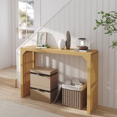 a wooden table with some boxes on it next to a stair case and potted plant