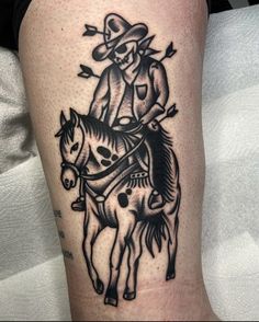 a man riding on the back of a horse wearing a cowboy hat and holding a lasso