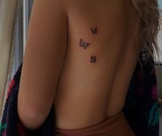 a woman with three butterflies on her back