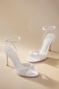 Elevate your ensemble with a touch of sophistication in every step with the Black Suede Studio Albie Bow Heels, showcasing a sleek design and charming bow detail. | Albie Bow Heels by Black Suede Studio in White, Women's, Size: 10, Leather/Satin at Anthropologie Graduation Heels, Elegant Wedding Shoes, Feather Heels, Fun Wedding Shoes, Sequin Heels, Black And White Heels, Ivory Wedding Shoes, Wedding Shoes Bride, Crystal Heels