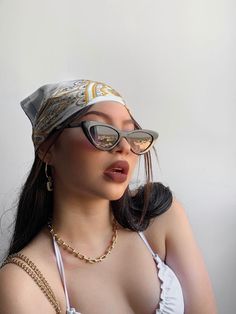 a woman wearing sunglasses and a bandana