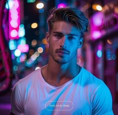 a man standing in the middle of a city at night wearing a white t - shirt