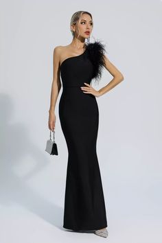 Elevate your style with the Tiana Black One Shoulder Feather Bandage Dress. This stylish and elegant dress features a sloping shoulder and sleeveless design, providing a slim and elongated silhouette. The feather adds a unique and glamorous touch. Perfect for any special occasion or formal event.  Dress Length: Approx 148cm Materials: Polyester Gentle Dry Clean Only  The model is 5 ft 7 and wears size S  Color may vary due to lighting on images. The product images (without a model) are closest t Black Dress With Feathers, Unique Dress Design, Embelished Dress, One Shoulder Dress Long, Silver Sequin Top, Gowns Elegant, Glitter Wedding Dress, Bandage Dress Black, Gowns Dresses Elegant