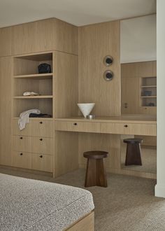 a bedroom with a bed, desk and shelves