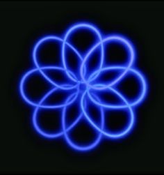 a blue flower is shown in the middle of a black background with light streaks on it