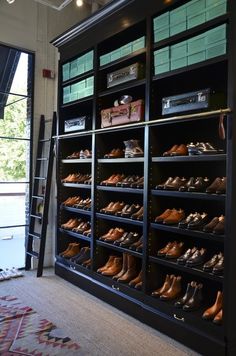 a room filled with lots of shoes next to a window