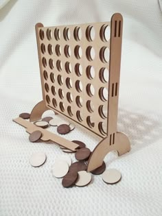 a wooden board game with lots of coins on the floor and one piece missing from it