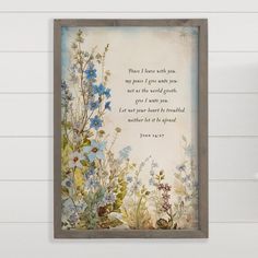 a painting on the wall with a bible verse written in blue and green flowers next to it