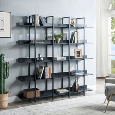 a living room filled with furniture and a book shelf next to a large potted cactus