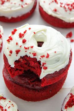 red velvet cupcakes with white frosting and sprinkles on top