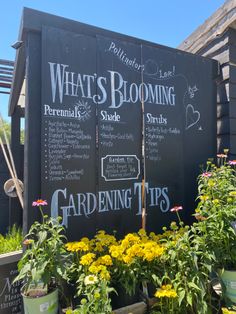 a blackboard sign that has some flowers in it