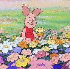 an animated pig holding a teddy bear in a field of flowers