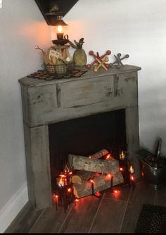 a fire place with candles and decorations on it