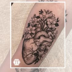 a black and white heart tattoo with flowers