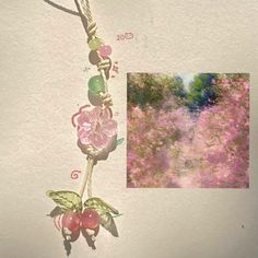 an image of a pink flowered tree with leaves and berries hanging from it's side