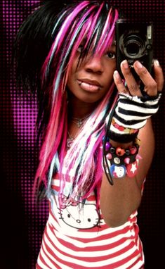 a woman with pink and black hair taking a selfie