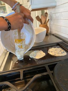 a person is mixing batter on top of an oven