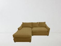 a brown sectional couch sitting on top of a white floor