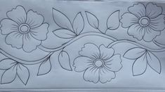 a piece of paper with flowers and leaves drawn on it's side, in black ink