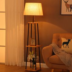 a living room scene with focus on the floor lamp and deer pillow in the corner