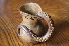 a small vase sitting on top of a wooden table