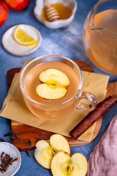 an apple cider with apples and cinnamon on the side, next to other ingredients