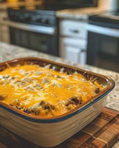 a casserole dish is sitting on a cutting board in front of an oven