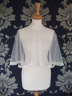 a mannequin wearing a white dress and veil