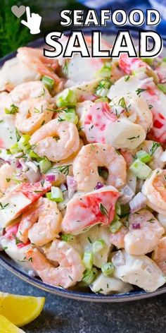 seafood salad in a bowl with lemon wedges