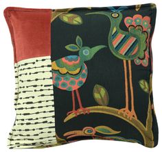 a black pillow with colorful birds on it