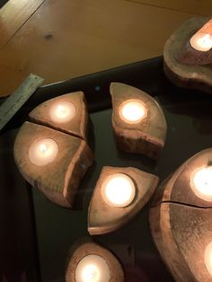 several wooden pieces with lit candles in them