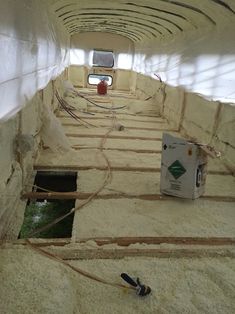 the inside of a building under construction with pipes running through it and water in the floor