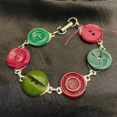 a bracelet with several different colored buttons on it