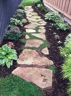 a stone path in the middle of a garden