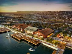 an artist's rendering of the waterfront at dusk, with boats in the water