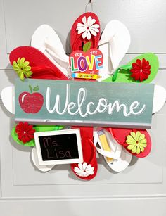 a welcome sign hanging on the front door to someone's school room or classroom