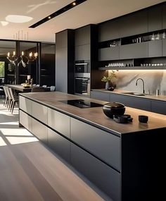 a modern kitchen with black cabinets and counter tops