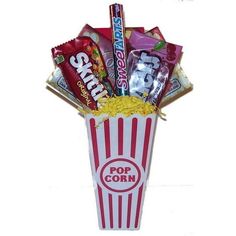 a popcorn box filled with snacks and candy