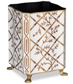 a white and gold planter with decorative designs on the sides, sitting in front of a white background