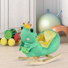 a small green toy with a crown on it's head sitting in a room