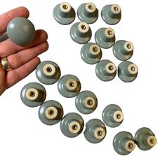 a hand holding a bunch of gray and white knobs