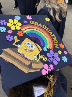 a graduation cap decorated with an image of spongebob and rainbow on the front